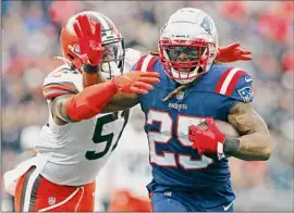  ?? Michael Dwyer / Associated Press ?? Patriots running back Brandon Bolden tries to break free from Browns outside linebacker Mack Wilson on Sunday at Gillette Stadium.