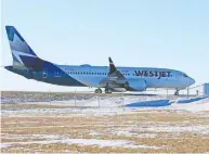 ?? GAVIN YOUNG / POSTMEDIA NEWS ?? A WestJet Boeing 737 Max taxis back to the WestJet hangars on Thursday after a training flight in Calgary.