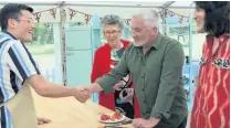  ??  ?? Honour Perthshire baker Michael gets the first handshake of the series from judge Paul Hollywood