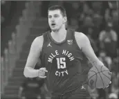  ?? JEFF CHIU/AP ?? DENVER NUGGETS CENTER NIKOLA JOKIC
(15) dribbles the ball up the court against the Golden State Warriors during the first half of Game 2 of a first-round playoff series in San Francisco, April 18.