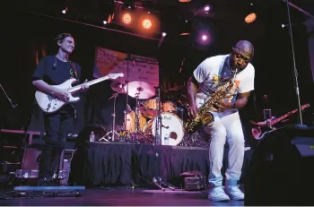  ?? MARK HUMPHREY/AP ?? Mike Phillips, right, performs on July 23 at the Jefferson Street Jazz & Blues Festival in Nashville, Tenn. The city is funding the event and other music-related projects with money from last year’s wide-ranging coronaviru­s relief law.