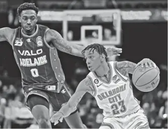  ?? BRYAN TERRY/THE OKLAHOMAN ?? Thunder guard Tre Mann (23) goes past the Adelaide 36ers’ Robert Franks (0) during an NBA preseason game Thursday night at Paycom Center.