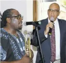  ?? ?? Musician Dwight Richards
(left) and cantor Kevin Williams entertain in song.