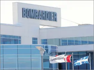  ?? CP PHOTO ?? Flags fly outside a Bombardier plant in Montreal, in 2015.