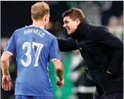  ??  ?? Steven Gerrard gives Scott Arfield advice