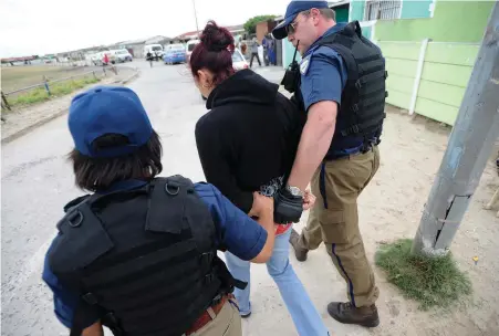  ?? PICTURE: ANA ?? NABBED: This woman was found with six bags of tik and R650 on a street corner near a house that was raided. It is believed she was linked to the house where the warrant was being executed in Retreat.