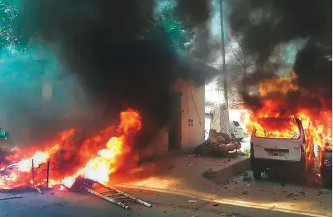  ?? PTI ?? Vehicles set alight by a group of protesters during the ‘Bharat Bandh’ call given by Dalit organisati­ons against the alleged dilution of the Scheduled Caste and Scheduled Tribe (Prevention of Atrocities) Act, in Meerut, Uttar Pradesh, on September 10.