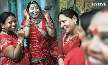  ?? Picture: AP ?? Hindu women wearing festive saris share a light moment after taking part in a procession as part of the Ganga Dussehra festival at a temple in New Delhi, India, this week. Hindus worship Ganga, or the Ganges, which they consider the most sacred river.