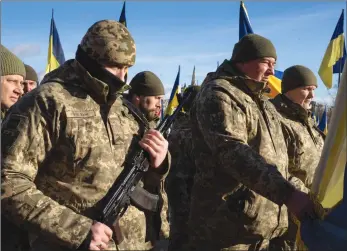  ?? The Associated Press ?? Ukrainian soldiers pay their last respects to their comrade Yuri Prykhodko, who was killed in Bakhmut, in the Donetsk region, at a city cemetery in Kyiv, on Tuesday.