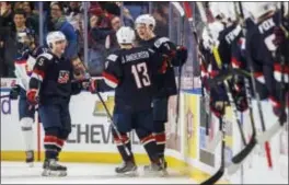  ?? MARK BLINCH — THE CANADIAN PRESS VIA AP ?? United States’ Brady Tkachuk, back right, celebrates his goal with teammates Joey Anderson and Scott Perunovich, left, against Slovakia in Buffalo, N.Y., on Thursday. Slovakia won, 3-2.