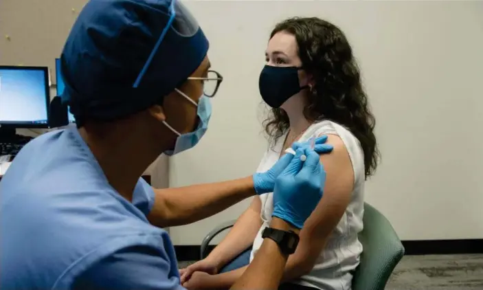  ?? Photograph: AFP/Getty Images ?? Volunteers are given the Moderna Covid vaccine in Detroit, Michigan on 5 August 2020.