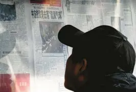  ?? ANDY WONG/AP ?? A man at a Beijing newsstand Monday reads about the government lodging a protest after the U.S. shot down a Chinese balloon, which landed off the South Carolina coast.