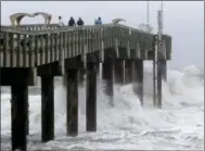  ?? MATT STAMEY — THE GAINESVILL­E SUN VIA THE ASSOCIATED PRESS ?? Ocean waves crash into a pier at St. Augustine, Fla., on Thursday at Hurricane Matthew closes in on the state’s eastern coast.