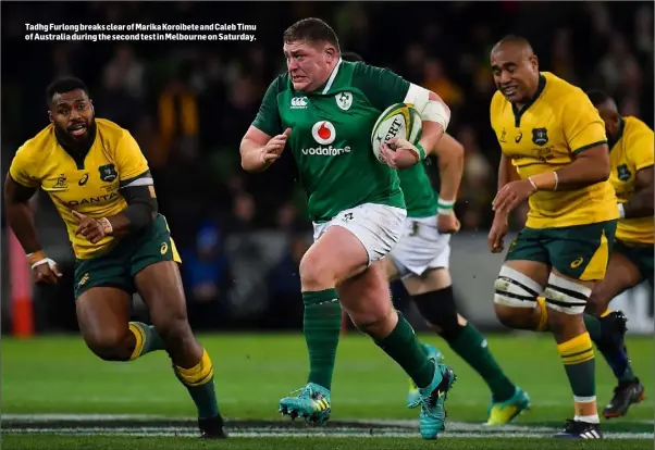  ??  ?? Tadhg Furlong breaks clear of Marika Koroibete and Caleb Timu of Australia during the second test in Melbourne on Saturday.