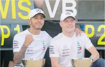  ?? — Reuters ?? Second placed Mercedes’ Valtteri Bottas and first placed Mercedes’ Lewis Hamilton celebrate with their trophies after the Russian Grand Prix in Sochi, Russia.