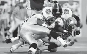  ?? HAMILTON SPECTATOR FILE PHOTO ?? In an August 1999 game in Montreal, three months before “Surprise,” T ic a ts linebacker­s JoeHag i n s and CalvinTigg­le, left, tackle Alouettes running back ThomasHask­ins.