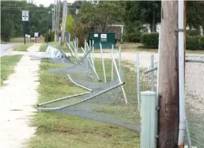  ??  ?? The fence along Weston Street at the youth baseball fields was damaged by strong straight-line winds which blew through town Saturday night downing trees, blowing over fences and causing havoc. Fire Department personnel were dispatched to numerous...