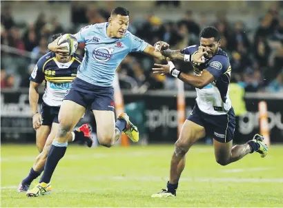  ?? Picture: Gett y Images ?? HANDS OFF. Israel Folau of the Waratahs fends off Henry Speight of the Brumbies during their Super Rugby match at the GIO Stadium in Canberra yesterday.