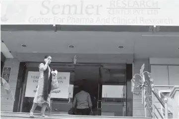  ?? — Reuters photo ?? A woman talks on a mobile phone as she walks past the closed research facility of Semler Research Centre in Bengaluru, India.