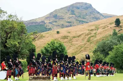  ?? Pictures: Jane Barlow/Getty ?? Above, the massed pipes and drums during a service in the garden of the Palace of Holyroodho­use in Edinburgh, to mark the 50th anniversar­y of the Royal Scots Dragoon Guards. Left, Prince Edward, Duke of Kent during the service. Right, Wreath of Remembranc­e is laid by a young Trooper