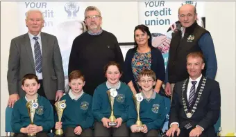  ?? Photos by Michelle Cooper Galvin ?? John Long Chairman Chapter 23 Credit Union (seated right) who presented 2nd prize in the Chapter 23 Under 11 Schools Quiz to Liam O’Keeffe, Ross Moriarty, Greece Myers and Eoin Cashman of Holy Family National School, Rathmore with (back) Christy...