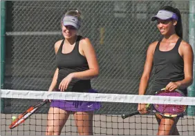  ?? Katharine Lotze/The Signal (See additional photos on signalscv.com) ?? Left: Valencia High’s No. 3 singles Jolie Ren returns a hit to her opponent during the Vikings match against Troy High on Monday. Right: Valencia High’s Taylor Cohen, right, and doubles partner Nicole Stefani smile after finishing a set against Troy...