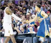  ?? Ezra Shaw Getty Images ?? L eBRON JAMES, left, shakes hands with Stephen Curry after the Warriors won the NBA title.