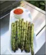  ?? ELIZABETH KARMEL VIA AP ?? This photo shows Grilled Asparagus with Romesco Sauce from a recipe by Elizabeth Karmel in Amagansett, N.Y.