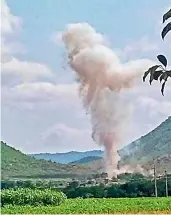  ??  ?? Smoke billows from a blast at a limestone quarry while a consignmen­t of gelatin sticks was being unloaded, at Kalasapadu Mandal in Kadapa district on Saturday. At least 10 workers died in the mishap.