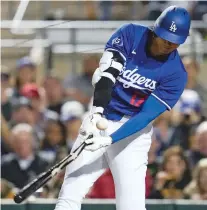  ?? ASHLEY LANDIS/THE ASSOCIATED PRESS ?? LEFT: Los Angeles Dodgers designated hitter Shohei Ohtani breaks a bat while hitting a foul ball Tuesday during a spring training game against the Los Angeles Angels in Phoenix.