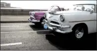  ?? Mcclatchy Newspapers/franco ORDONEZ ?? Vintage American automobile­s, a common sight around Havana, cruise along the city’s famed Malecon promenade.