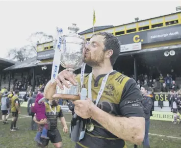  ??  ?? 2 Melrose captain Grant Runciman kisses the BT Premiershi­p trophy following his side’s victory over Ayr.