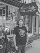  ?? TY WRIGHT/THE ADVOCATE ?? Jay Snyder, owner of Steamrolle­r Bagel Sandwiches, stands out in front of the Steamrolle­r Bagel Sandwich Shop in downtown Granville, Ohio on April 20. Snyder recently announced he plans to close the business in December.