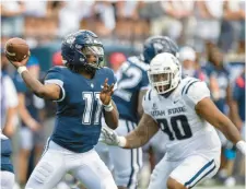  ?? TYLER TATE/AP ?? Uconn quarterbac­k Zion Turner passes while avoiding Utah State defensive tackle Phillip Paea on Saturday in Logan, Utah.