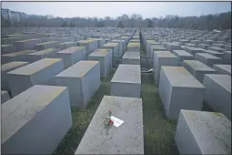  ?? (AP/Markus Schreiber) ?? Roses with a note saying “#weremember” are seen on the Holocaust Memorial on Internatio­nal Holocaust Remembranc­e Day in Berlin on Jan. 27.