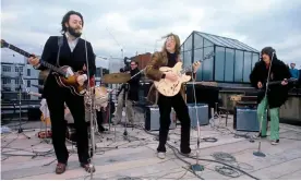  ?? Ethan A Russell/Apple Corps Ltd ?? The Beatles’ outdoor performanc­e on the rooftop of their Apple Corps HQ in 1969. Photograph: