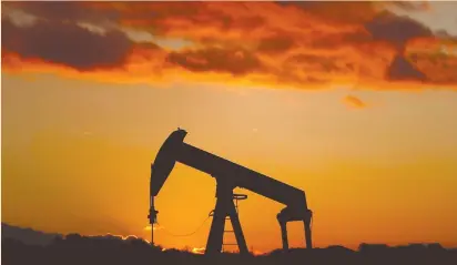  ?? (Christian Hartmann/Reuters) ?? AN OIL PUMP is seen at sunset outside Scheibenha­rd, near Strasbourg, France.