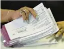  ?? ?? Faith Evan-Barnes counts a batch of mail-in ballot envelopes before tallying on the first day of canvassing the mail-in ballots at Baltimore’s elections warehouse.