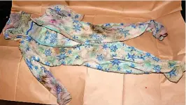  ?? CPS ?? The wet and vomit-stained Frozen onesie that police found hidden in the living room and, right, part of the cluttered house