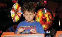  ?? Nikolas Samuels/The Signal ?? Kaine Scott, 6, plays video games at a local arcade in Santa Clarita on Friday. The World Health Organizati­on says that in order for someone to be classified with a “gaming disorder,” the behavior must cause ‘significan­t impairment’ to one’s life.