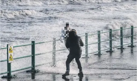  ??  ?? Taking pictures as waves hit sea walls. Picture by North News.