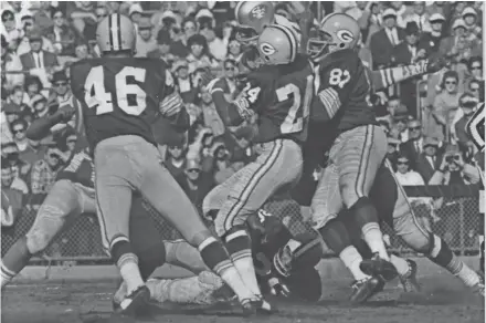  ?? JOURNAL SENTINEL FILES ?? Willie Wood (24), Willie Davis (87) and Herb Adderley (on the ground) are all in the top 15.