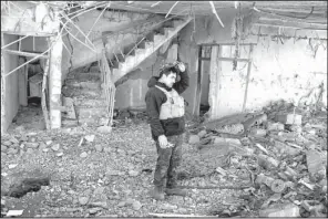  ?? AP/BRAM JANSSEN ?? stands inside a damaged house Sunday after it was hit by an airstrike in