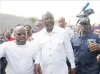  ?? — Reuters ?? George Weah (C) arrives to cast his ballot during presidenti­al elections at a polling station in Monrovia on Tuesday.