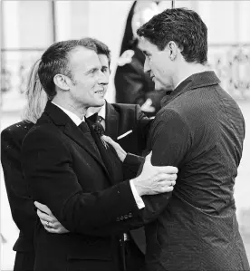  ?? ADRIAN WYLD THE CANADIAN PRESS ?? French President Emmanuel Macron greets Prime Minister Justin Trudeau as he arrives at the Palais de l'Élysée in Paris, France, Sunday.