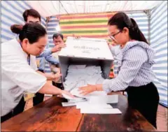  ?? HENG CHIVOAN ?? Officials begin counting votes on Sunday in the capital’s Boeung Prolit commune.