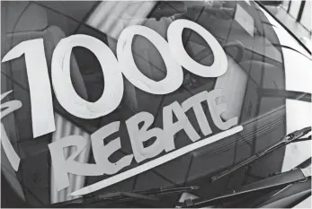  ?? WILLIAM ARCHIE, DETROIT FREE PRESS ?? Car rebates aren’t always obvious and painted on a windshield. It can help consumers to do some research to find what the real incentives are before shopping around.