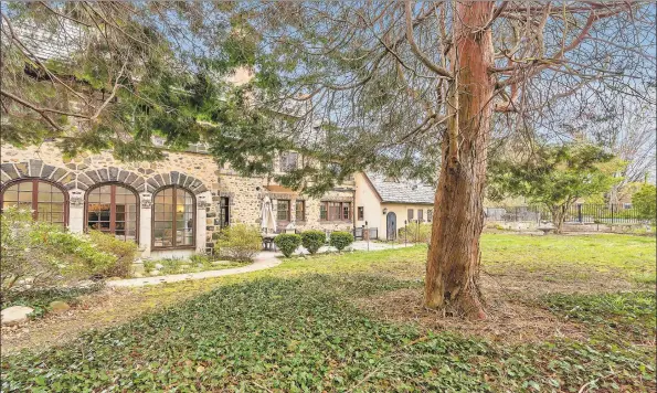  ?? Real Living Wareck D’Ostilio / Contribute­d photos ?? This Tudor mansion features stone patios, landscaped gardens, private backyard and an in-ground heated pool.
