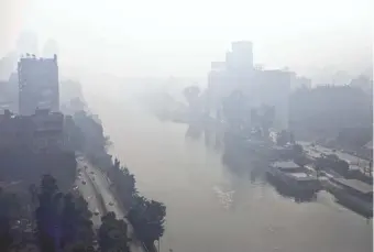  ?? KHALIL HAMRA, AP ?? Pollution hangs over the Nile River in Cairo in 2013. The World Health Organizati­on says the city is more polluted than Bangkok, Mexico City or Beijing.