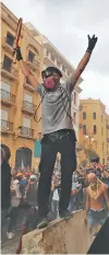  ?? HASSAN AMMAR/ASSOCIATED PRESS ?? Protesters celebrate Monday after opening a road leading to the Parliament building in Beirut.